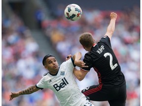 Cristian Techera of the Vancouver Whitecaps, left, battles for ball possession with D.C. United's Taylor Kemp during Saturday's MLS game in Vancouver.