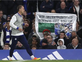 Chelsea's English defender John Terry (L) warms up by a banner supporting him during the English Premier League football match between Chelsea and Middlesbrough at Stamford Bridge in London last week.