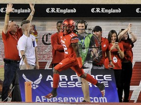 Justin Thomas of the Utah Utes skips through the end zone after he scored a 4th quarter touchdown off an interception against the Michigan Wolverines at Rice-Eccles Stadium on September 3, 2015 in Salt Lake City, Utah. Utah won 24-17.