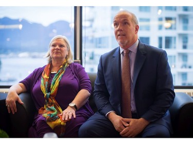 B.C. NDP Leader John Horgan and his wife Ellie watch election results on television at a hotel after the provincial election polls closed, in Vancouver, B.C., on Tuesday May 9, 2017.