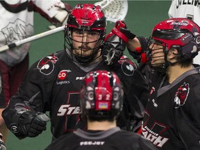 Vancouver Stealth's Corey Small, in back, celebrates his goal against the Colorado Mammoth with teammates James Rahe, front, and Jordan Durston, right, in a regular-season NLL game at Langley on April 22.