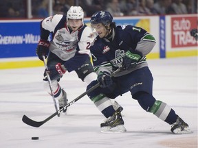 Windsor Spitfires centre Logan Brown pressures Seattle Thunderbirds center Mathew Barzal during the first period of a Memorial Cup round robin hockey game in Windsor last Sunday.