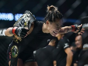 Angela Lee celebrates after defeating Istela Nunes of Brazil in the women's atomweight world championship bout during the One Championship Dynasty of Heroes at the Singapore Indoor Stadium on Friday in Singapore.
