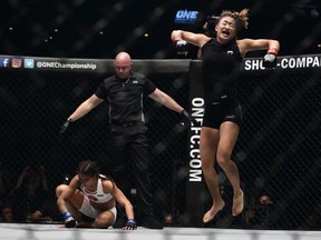 Angela Lee celebrates after defeating Istela Nunes of Brazil in the women's atomweight world championship bout during the One Championship Dynasty of Heroes at the Singapore Indoor Stadium on Friday.