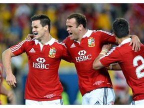 British and Irish Lions flyhalf Jonathon Sexton is congratulated by teammates Jamie Roberts and Connor Murray after scoring a try against the Australian Wallabies attackers in the third rugby Test match played in Sydney on July 6, 2013.