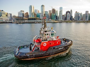 Seaspan tug Season Raven manoeuvres in front of Canada Place in Burrard Inlet.