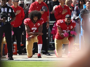 SANTA CLARA, CA - OCTOBER 23:  Eric Reid #35 and Colin Kaepernick #7 of the San Francisco 49ers kneel in protest during the national anthem prior to their NFL game against the Tampa Bay Buccaneers at Levi's Stadium on October 23, 2016 in Santa Clara, California.