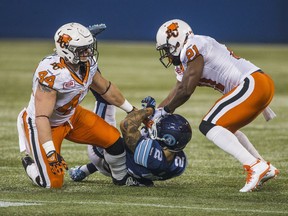 Adam Bighill, left, and Ryan Phillips, right, are no longer part of a B.C. Lions defence that gave up the fewest yards in the league last season, having departed for other football opportunities.