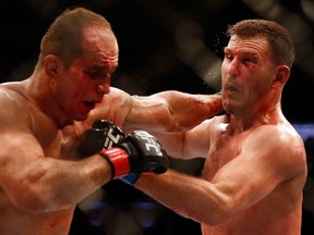 Junior dos Santos, left, and Stipe Miocic exchange punches in their heavyweight bout during UFC Fight Night at the U.S. Airways Center on Dec. 13, 2014, in Phoenix.