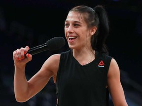UFC women's strawweight champion Joanna Jedrzejczyk talks to the crowd during UFC 205 Open Workouts at Madison Square Garden in November 2016.