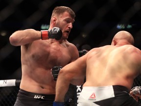 DALLAS, TX - MAY 13:  (L-R) Stipe Miocic  fights against Junior Dos Santos in their Heavyweight Title bout during UFC 211 at American Airlines Center on May 13, 2017 in Dallas, Texas.  (Photo by Ronald Martinez/Getty Images)