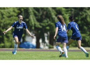 Liesanne Musico of the Fleetwood Park Dragons, left, celebrates her team's winning goal against the Handsworth Royals in last June's triple-A championship final of the B.C. girls high school soccer championships in Tsawwassen.