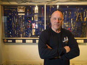 Retired poilceman Al Arsenault in front of "Arsenault's Arsenal," a collection of weapons the Vancouver police have seized off the streets.