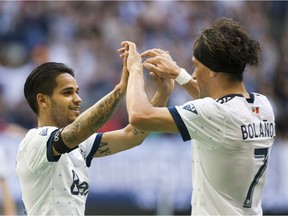 Whitecaps Cristian Techera, left, and Christian Bolanos celebrate Techera's goal off a pass from Bolanos against Sporting KC during Saturday's game at B.C. Place.