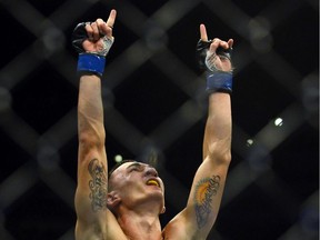 In this Aug. 11, 2012, file photo, Max Holloway celebrates his win over Justin Lawrence in their featherweight bout during UFC 150 in Denver.