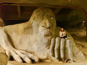 Climbing up for a photo op on the Fremont Troll, which lurks under a bridge in a Seattle neighbourhood, is actually encouraged.