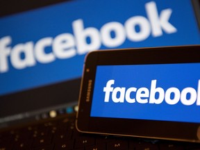 (FILES) This file photo taken on November 21, 2016 shows Facebook logos pictured on the screens of a smartphone (R), and a laptop computer, in central London. Facebook announced on December 15, 2016 it was offering a tool allowing users to report fake news, a move aimed at stemming a wave of misinformation which some claim influenced the 2016 US election."We believe in giving people a voice and that we cannot become arbiters of truth ourselves, so we're approaching this problem carefully," Facebook's vice president Adam Mosseri said in a blog post.  / AFP PHOTO / Justin TALLISJUSTIN TALLIS/AFP/Getty Images