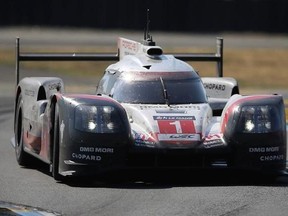 The Porsche 919 Hybrid No. 1 of the Porsche Team driven by Neel Jani of Switzerland, Andre Lotterer of Germany and Nick Tandy of Britain races in a curve during the 85th 24-hour Le Mans endurance race in Le Mans, western France, Sunday, June 18, 2017. (AP Photo/David Vincent)