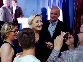 French far-right candidate, Marine Le Pen poses for a photograph after her speech during the second round of parliamentary elections in Henin Beaumont, Northern France, Sunday, June 18, 2017. French voters are casting ballots Sunday in the final round of parliamentary elections that could clinch President Emmanuel Macron&#039;s hold on power, as his fledgling party appears set to rout mainstream rivals and turn politics as usual on its head. (AP Photo/Michel Spingler)