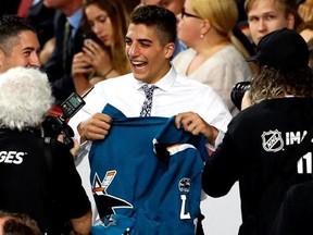 Mario Ferraro smiles as he holds a San Jose Sharks jersey after being selected by the team during the second round of the NHL hockey draft, Saturday, June 24, 2017, in Chicago. (AP Photo/Nam Y. Huh)