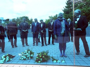 German officials look at a monument in Berlin dedicated to over 200,000 victims of the euthanasia program used by Hitler to kill people with mental and physical illnesses.