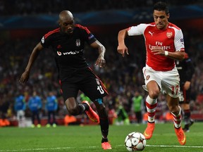 Arsenal's Chilean striker Alexis Sanchez (R) takes on Besiktas' Canadian midfielder Atiba Hutchinson (L) during the UEFA Champions League qualifying round play-off second-leg football match between Arsenal and Besiktas' at the Emirates Stadium in London in 2014.
