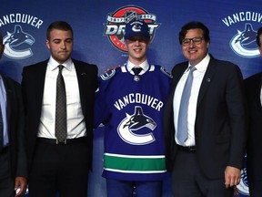 Elias Pettersson poses for photos after being selected fifth overall by the Vancouver Canucks during the 2017 NHL Draft at the United Center on June 23, 2017, in Chicago, Illinois.