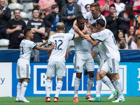 Vancouver Whitecaps' Cristian Techera, from left to right, Fredy Montero, Kendall Waston, Jordan Harvey, Tim Parker, Matias Laba, Andrew Jacobson and Tony Tchani celebrate Waston's second goal against Atlanta United during the first half of an MLS soccer game in Vancouver, B.C., on Saturday June 3, 2017.