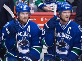 Vancouver Canucks' Daniel Sedin, left, and his twin brother Henrik Sedin say they're anxious to get to work with Canucks new coach Travis Green.