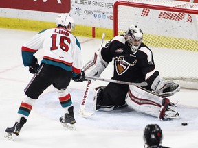 Goaltender Ryan Kubic of the Vancouver Giants makes a save against Kole Lind of the Kelowna Rockets during the second period of their WHL game at the Langley Events Centre on November 4, 2016 in Langley.