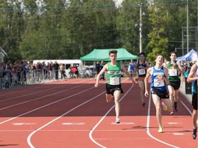 Tyler Dozzi of Oak Bay is passed at the last moment by Charlie Dannatt of Handsworth to win the boys 3,000 metres at the 2017 B.C. High School Track Championships.