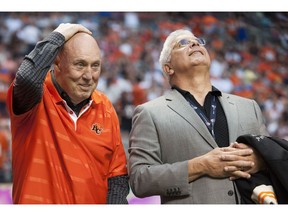 Former Lion coach Don Matthews rubs his hand over a bald head after GM Wally Buono made a comment about his hair during the team's Wall of Fame ceremony at B.C. Place Stadium on July 20, 2013. Don Matthews died Wednesday at age 77.