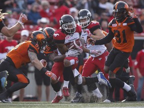 BC Lions' players tackle Calgary Stampeders' Jamal Nixon during CFL pre-season football action in Calgary, Tuesday, June 6, 2017.
