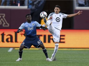 Minnesota United defender Kevin Venegas, right, and Vancouver Whitecaps forward Alphonso Davies compete for the ball during their 2-2 draw Saturday in Minneapolis. Davies is one of several Whitecaps who could be called up by Canada for the Gold Cup.