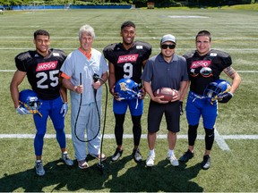 Canadian Football Hall of Famer Lui Passaglia poses in hospital scrubs while holding a colonoscope for a campaign supported by entrepreneur and philanthropist Jack Gin (holding football). UBC Thunderbird players, from left, Jordan Kennedy, Malcom Lee and Stavros Katsantonis volunteered their time for the promotion.