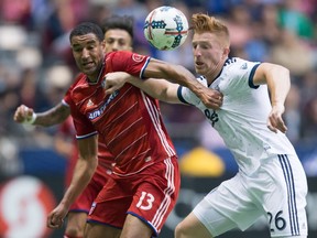 FC Dallas's Tesho Akindele, left, and Vancouver Whitecaps' Tim Parker battle during the first half of Saturday's game at B.C. Place Stadium.