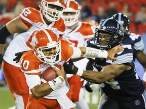 Quarterback Jonathon Jennings of the B.C. Lions battles Victor Butler of the Argonauts during CFL action in Toronto on June 30.