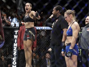 Amanda Nunes, left, celebrates her win as Ronda Rousey stands at right, after their women's bantamweight championship mixed martial arts bout was stopped in the first round at in Las Vegas in December.