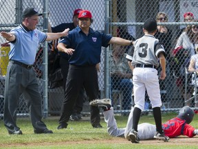 Ump Sante Delvecchio calls Hastings Community Little Leaguer Antonio Cusati safe at third after a play by Diamond Baseball Academy's Jacob Blais at the Canadian Little League Championships in Vancouver on Aug. 10, 2016.