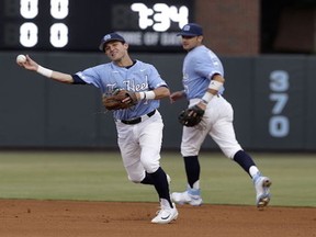 North Carolina shortstop Logan Warmoth (7) throws out a Davidson runner during the first inning of an NCAA college baseball tournament regional game in Chapel Hill, N.C., Sunday, June 4, 2017.