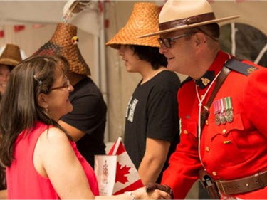 Gloria Cardenas (left) is congratulated on becoming a Canadian by RCMP Sgt. Chad Greig.
 FORT LANGLEY, July 01 2017. Fort Langley Canada Day citizenship ceremony dignitaries present Judge Gerald Pash, MP John Aldag, MLA Rich Coleman, Mayor Jack Froese, Indigenous people representative Chief Marilyn Gabriel, Kevin Kelly, Michael Kelly Gabrile, RCMP officer Sergent Chad Greig, Clerk Jason Jansen, Ft. Langley, July 01 2017. Reporter: Sam Cooper, ( Francis Georgian  /  PNG staff photo)  ( Prov / Sun News ) 00049707A  [PNG Merlin Archive]