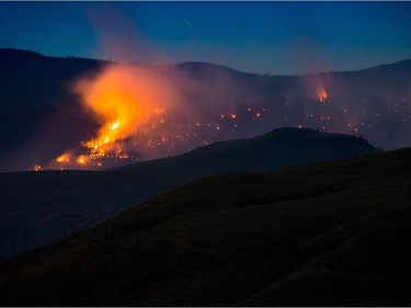 A wildfire burns on a mountain near Ashcroft, B.C., late Friday July 7, 2017. More than 3,000 residents have been evacuated from their homes in central British Columbia. A provincial state of emergency was declared after 56 new wildfires started Friday. THE CANADIAN PRESS/Darryl Dyck ORG XMIT: VCRD125