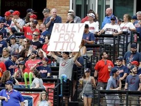 A fan holds up a sign reading &ampquot;Rally for Tito&ampquot; in the first inning of a baseball game between the Detroit Tigers and the Cleveland Indians, Friday, July 7, 2017, in Cleveland. Indians manager Terry Francona underwent a procedure Thursday to correct an irregular heartbeat that sidelined him for a few games and will prevent him from managing in the All-Star Game next week.(AP Photo/Tony Dejak)