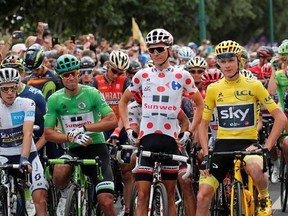 Britain&#039;s Chris Froome, wearing the overall leader&#039;s yellow jersey, Australia&#039;s Michael Matthews, wearing the best sprinter&#039;s green jersey, France&#039;s Warren Barguil, wearing the best climber&#039;s dotted jersey and Britain&#039;s Simon Yates, wearing the best young rider&#039;s white jersey, wait for the start of the twenty-first and last stage of the Tour de France cycling race over 103 kilometers (64 miles) with start in Montgeron and finish in Paris, France, Sunday, July 23, 2017. (AP Photo/Christophe Ena)