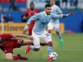 FILE - In this April 22, 2017, file photo, Sporting Kansas City forward Dom Dwyer (14) takes control of the ball against FC Dallas defender Walker Zimmerman (25) during the first half of an MLS soccer match, in Frisco, Texas. Sporting Kansas City forward Dom Dwyer has been traded to Orlando City for what could be a Major League Soccer record $1.6 million in allocation money. (AP Photo/LM Otero, File)