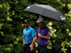 Adam Hadwin and Nick Taylor walk the fairway during the final round of the Crowne Plaza Invitational at the Colonial Country Club on May 24, 2015 in Fort Worth, Texas. The B.C.-raised golfers are paired together for the Canadian Open starting Thursday.