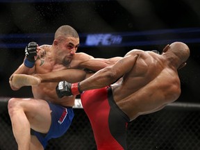 Robert Whittaker punches Yoel Romero in their interim UFC middleweight championship bout during the UFC 213 event at T-Mobile Arena on Saturday in Las Vegas, Nevada.