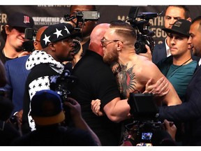 Floyd Mayweather Jr. and Conor McGregor, right, get into each other's grill during their World Press Tour event at Barclays Center on July 13 in New York City.