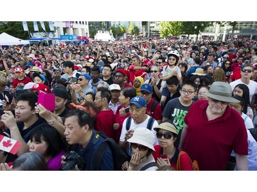 The crowd sings O Canada at the Canada Day celebrations at Canada Place, Vancouver, July 01 2017.