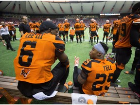 B.C. Lions' ace defenders T.J. Lee, left, and Ronnie Yell discuss game strategy while sitting on the players' bench.